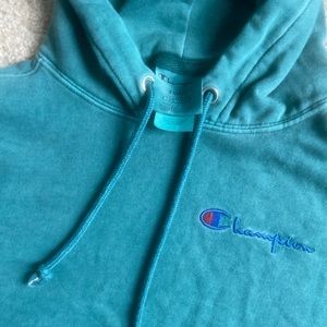 Green champion hoodie.